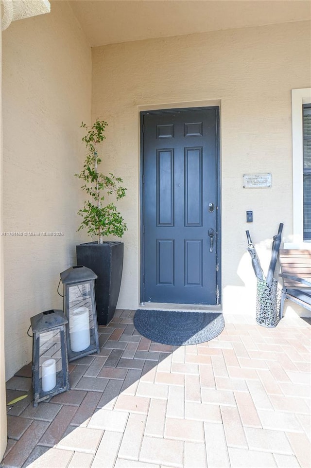 747 NE 193rd Ter, Miami, FL 33179 - doorway to property with stucco siding