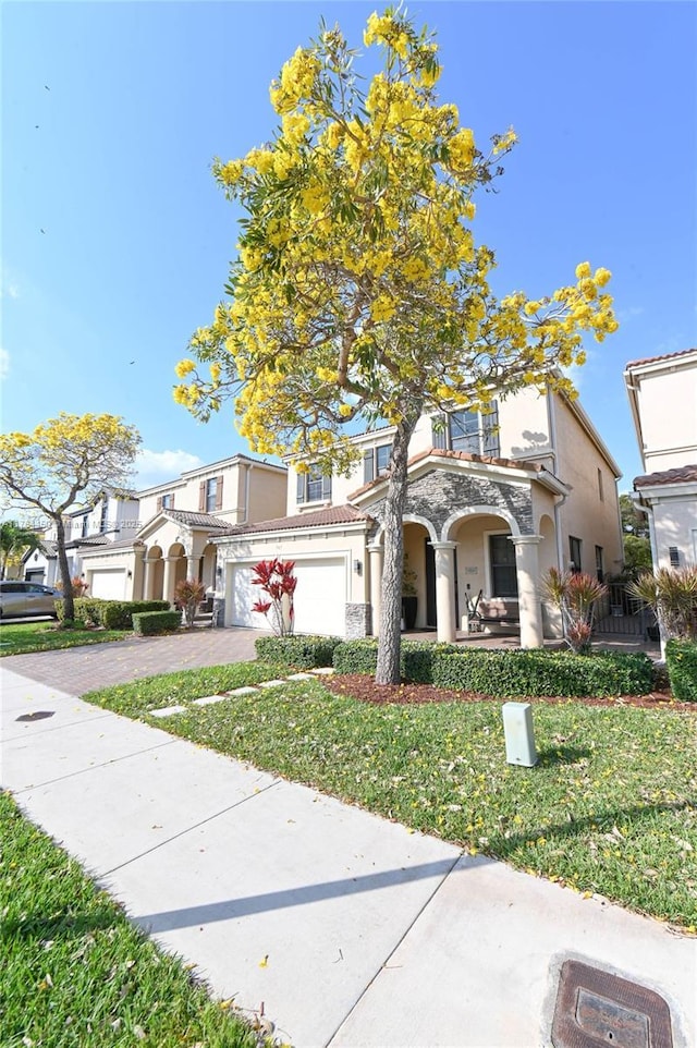 747 NE 193rd Ter, Miami, FL 33179 - view of front of home featuring a front lawn, driveway, and stucco siding