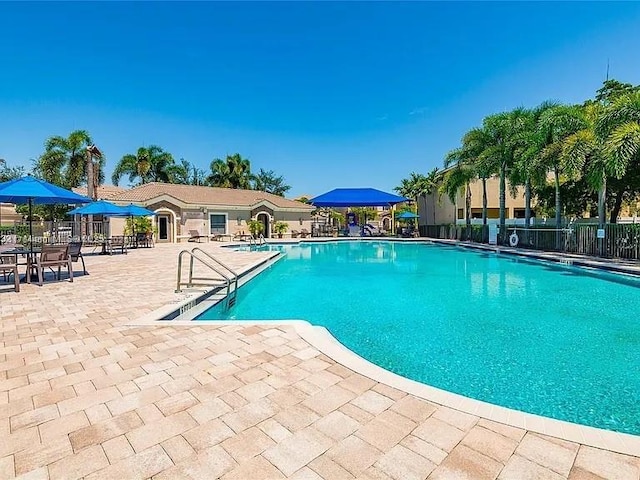 747 NE 193rd Ter, Miami, FL 33179 - community pool featuring a patio area and fence