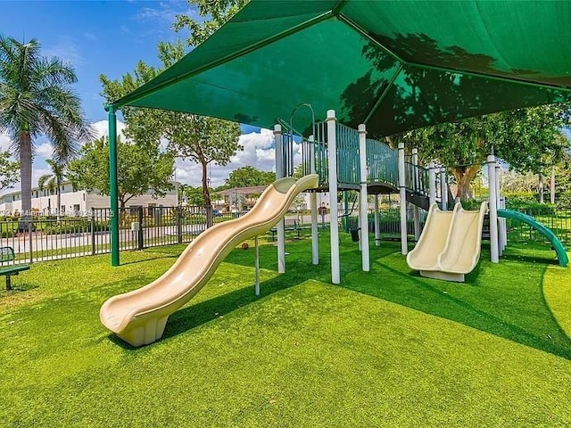 747 NE 193rd Ter, Miami, FL 33179 - community jungle gym with a lawn and fence