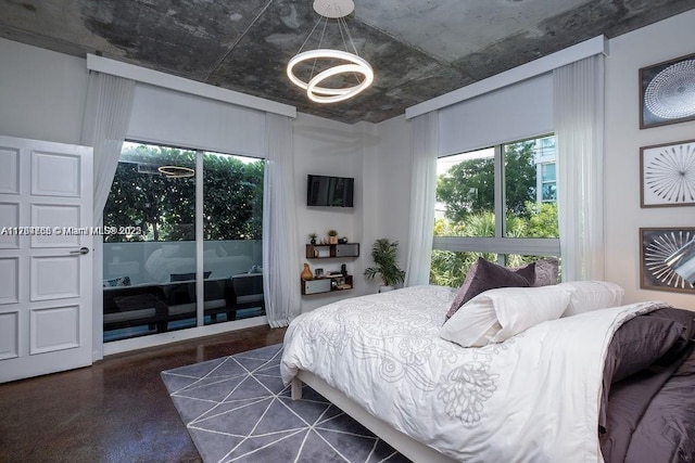 bedroom with access to exterior and a notable chandelier