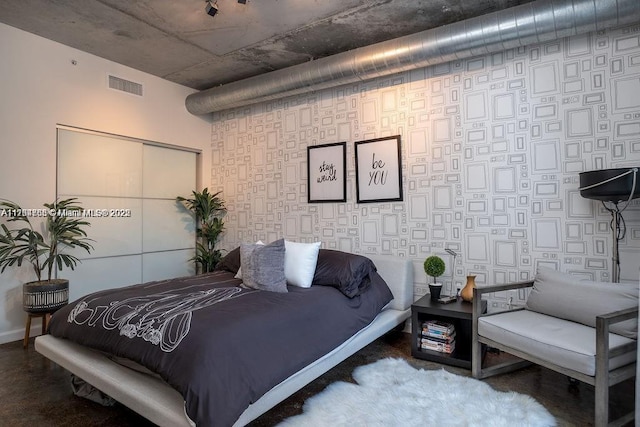bedroom with baseboards and visible vents