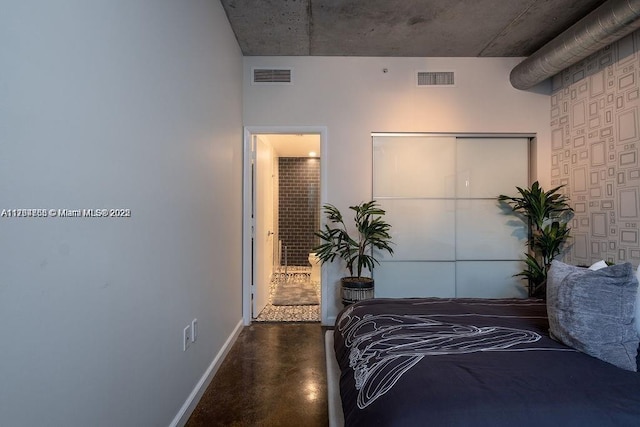 bedroom featuring visible vents, baseboards, a closet, and finished concrete floors