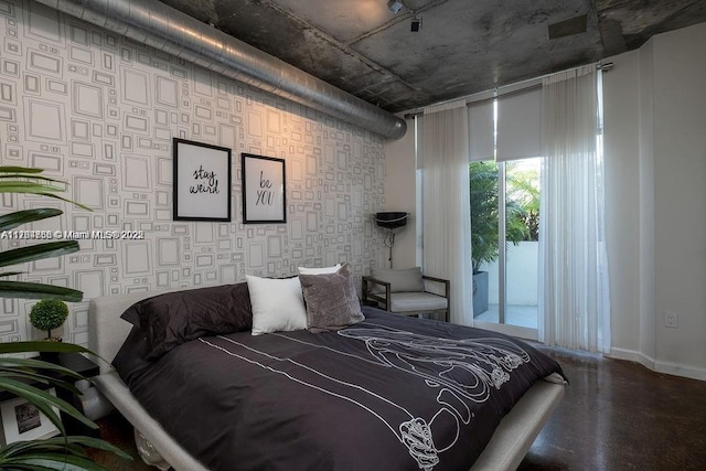 bedroom with access to exterior, wallpapered walls, and baseboards