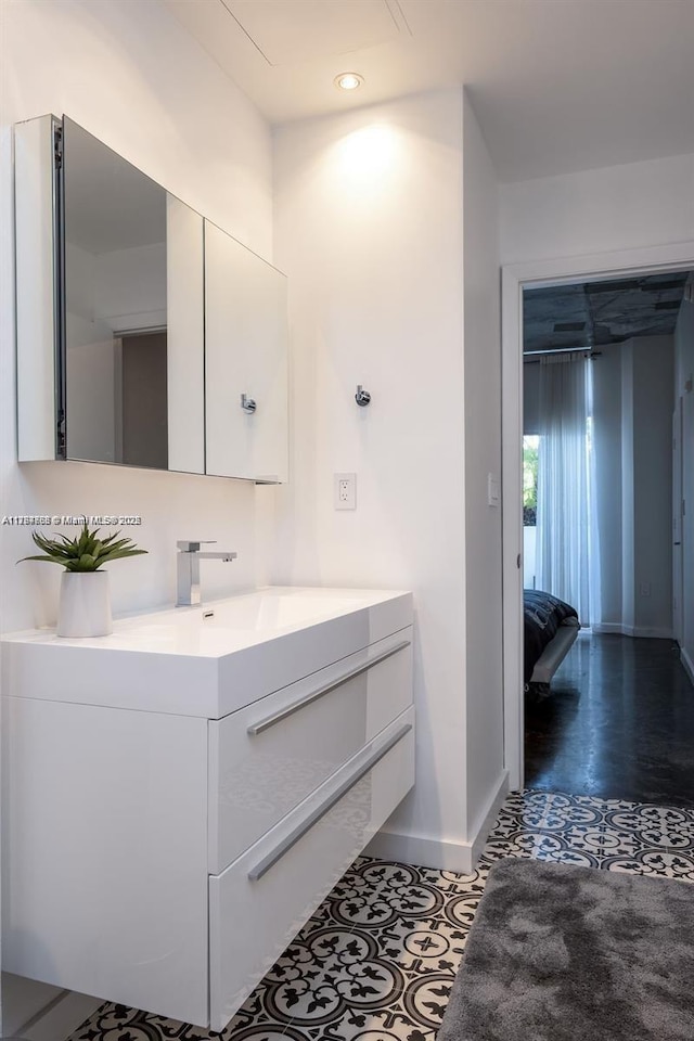bathroom with recessed lighting, vanity, and baseboards