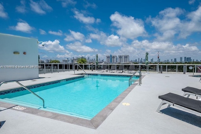 pool featuring a view of city and a patio