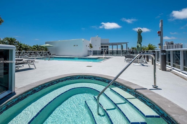 pool featuring a patio area and a hot tub