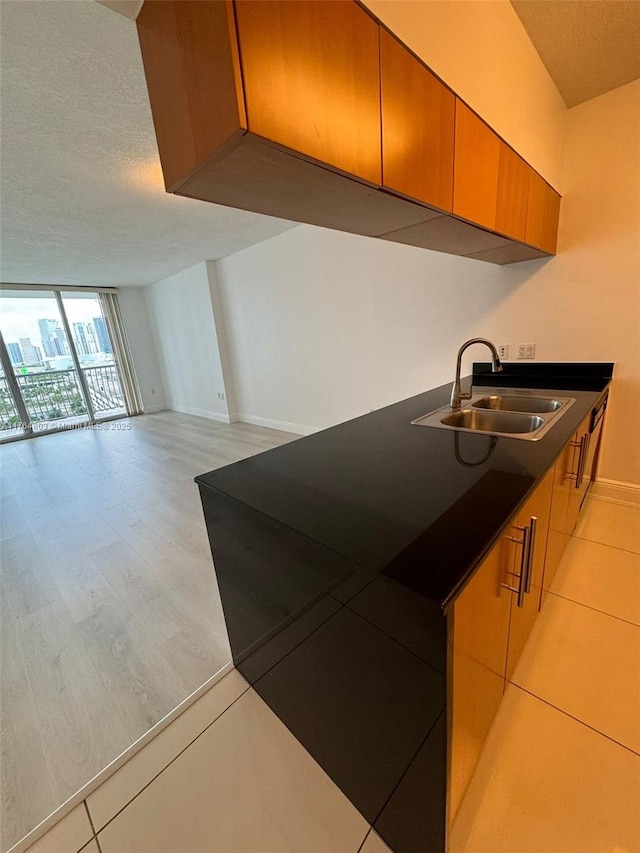 1750 N Bayshore Dr Unit 1606, Miami, FL 33132 - kitchen with a sink, baseboards, a textured ceiling, expansive windows, and open floor plan