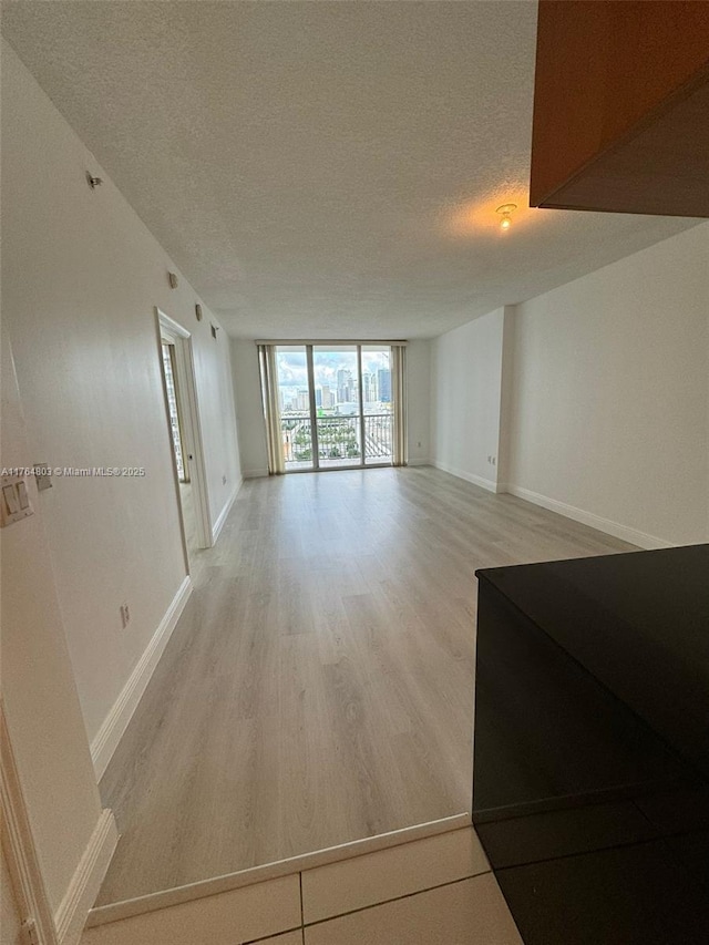 1750 N Bayshore Dr Unit 1606, Miami, FL 33132 - unfurnished room with a textured ceiling, light wood finished floors, and baseboards