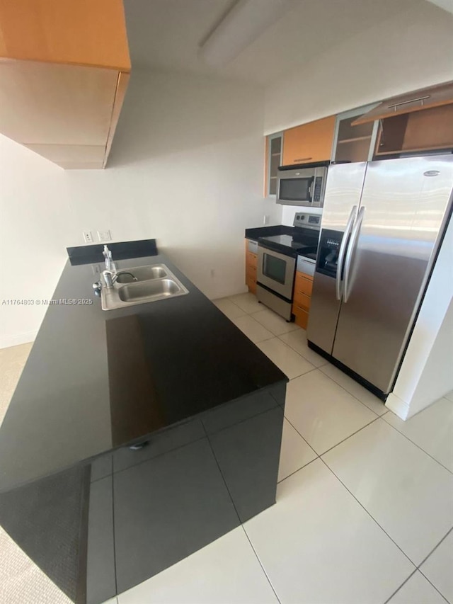 1750 N Bayshore Dr Unit 1606, Miami, FL 33132 - kitchen with stainless steel appliances, a sink, light tile patterned floors, and brown cabinets