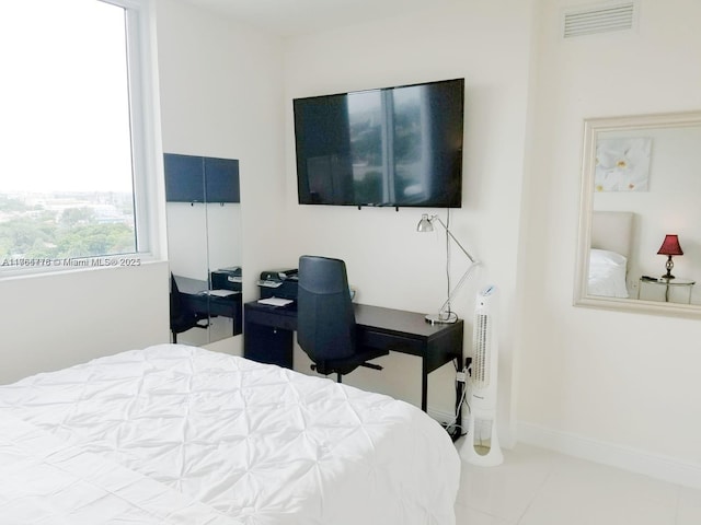 tiled bedroom featuring visible vents and baseboards