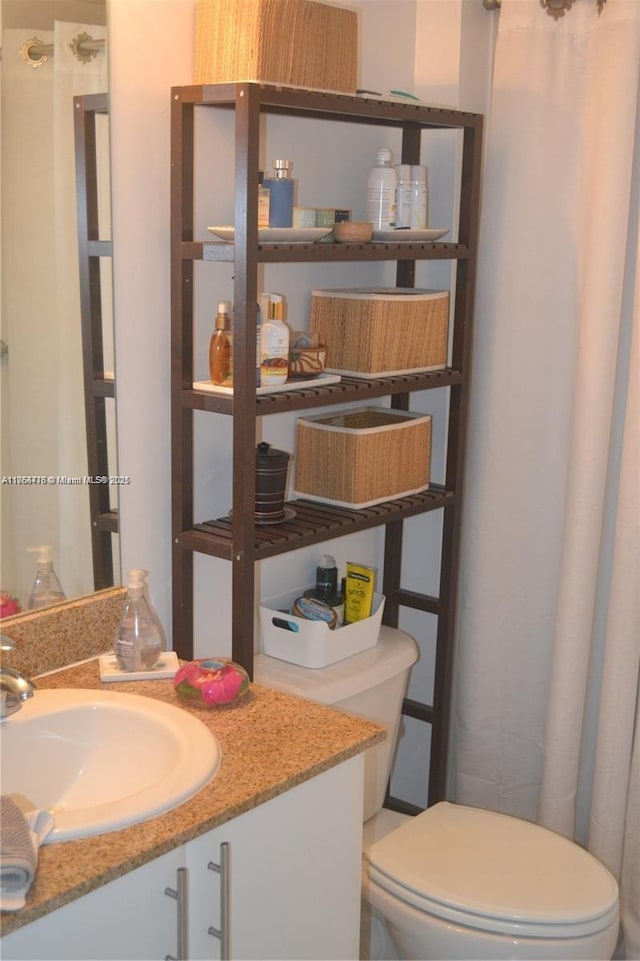 bathroom featuring toilet and vanity