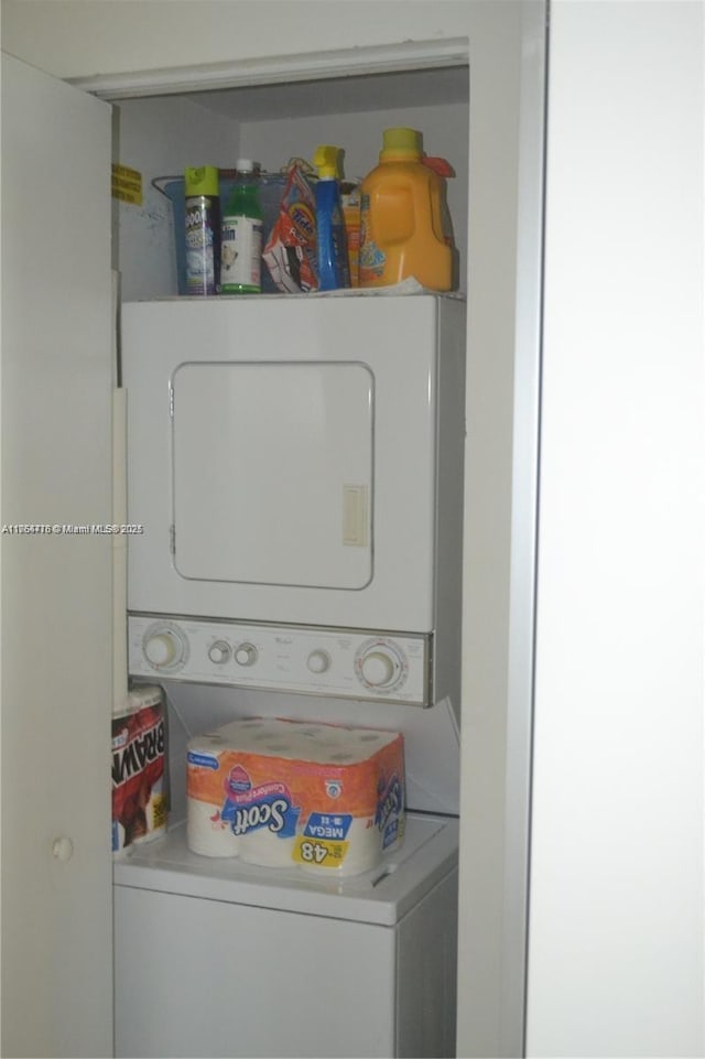 laundry area with stacked washer / dryer and laundry area