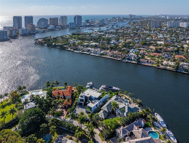 birds eye view of property with a view of city and a water view