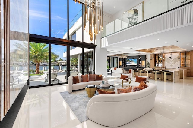 living room with floor to ceiling windows and a high ceiling