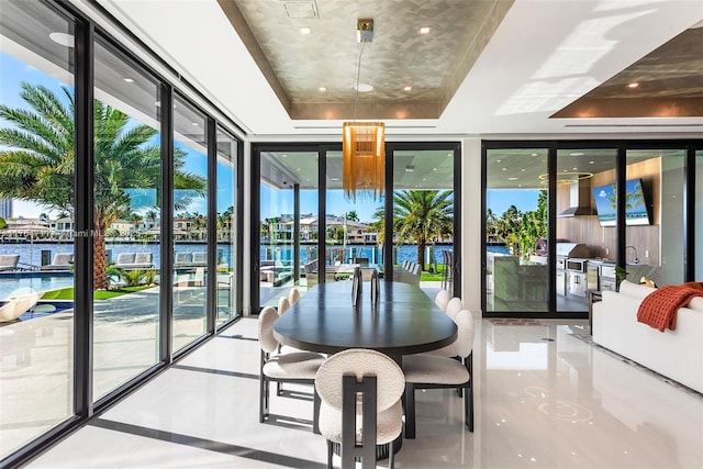 sunroom featuring a tray ceiling