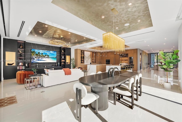 dining space with recessed lighting, a tray ceiling, and tile patterned floors