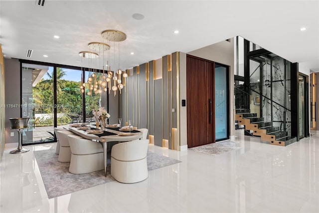 dining space featuring stairs, a wall of windows, recessed lighting, and a chandelier