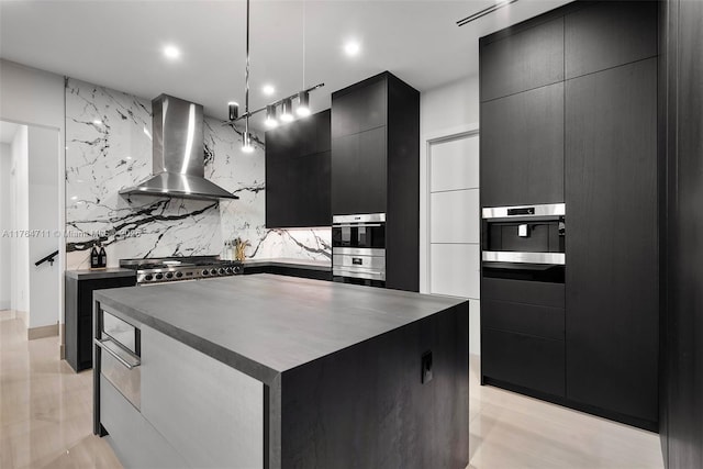 kitchen with stove, wall chimney exhaust hood, modern cabinets, and dark cabinets