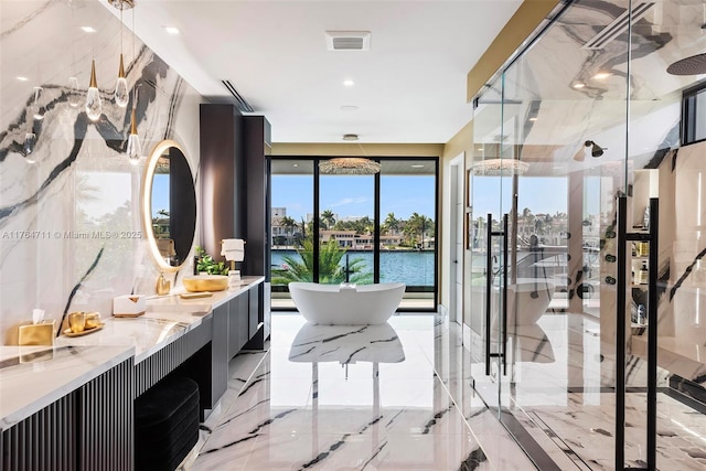 bathroom featuring a marble finish shower, visible vents, a soaking tub, marble finish floor, and vanity