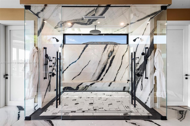 interior space featuring marble finish floor and a marble finish shower