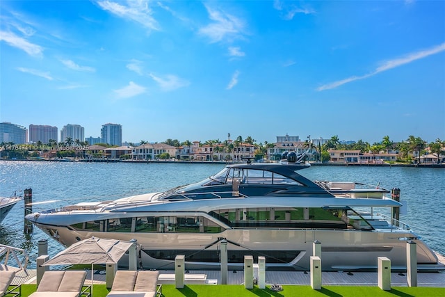 view of dock with a city view and a water view