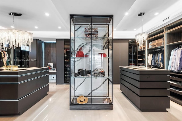 walk in closet with a notable chandelier