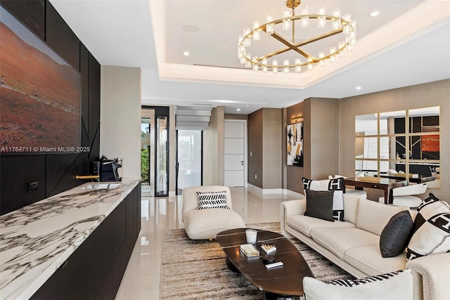 living room with a chandelier, recessed lighting, and a raised ceiling