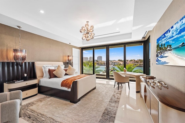 bedroom with a raised ceiling, a view of city, recessed lighting, and a chandelier