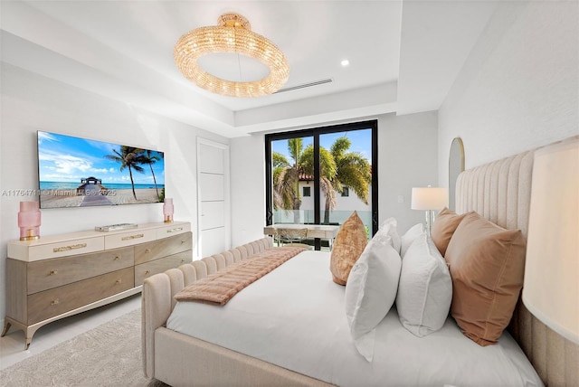 bedroom featuring access to exterior, visible vents, and a tray ceiling