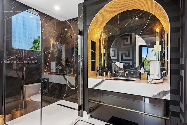 full bathroom with vanity and a marble finish shower