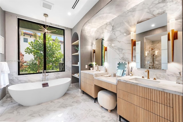 full bathroom with visible vents, marble finish floor, a shower stall, a freestanding bath, and stone wall