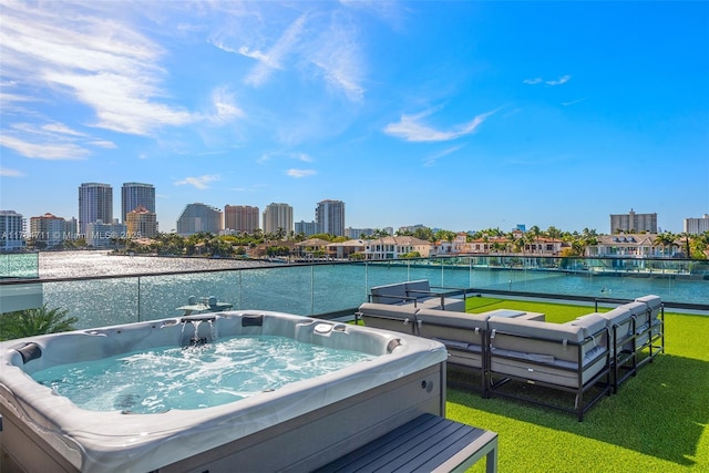 view of swimming pool featuring a view of city, an outdoor hot tub, and a water view