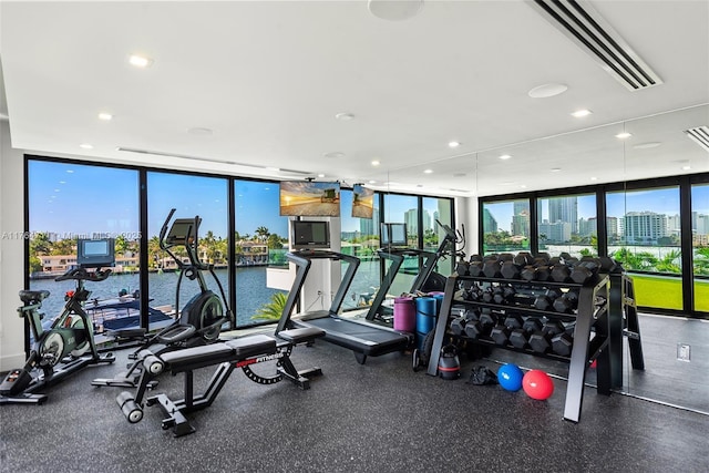 gym with a wall of windows and recessed lighting