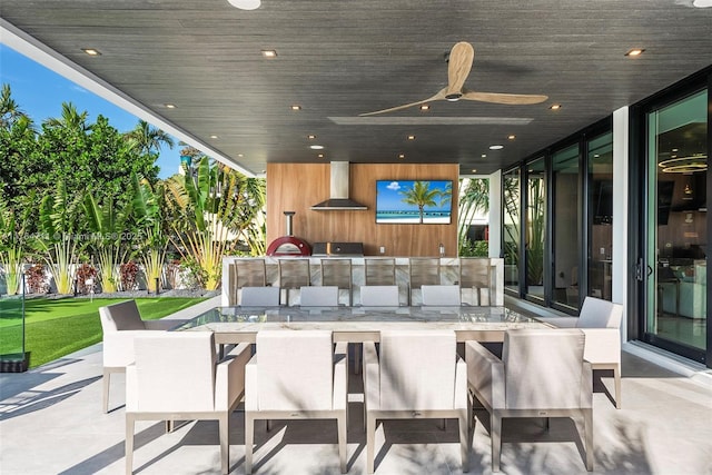 view of patio / terrace featuring ceiling fan, outdoor wet bar, and an outdoor kitchen