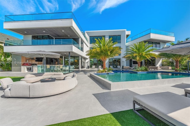 pool featuring an outdoor hangout area and a patio area