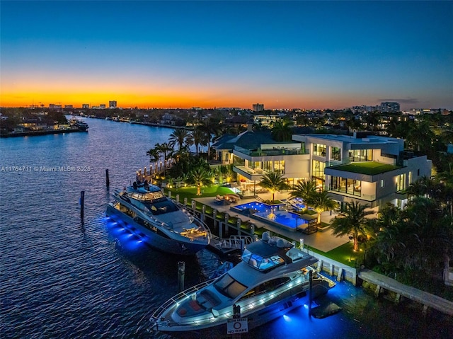 aerial view at dusk with a water view