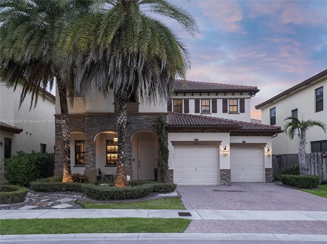 9835 NW 86th Ter, Doral, FL 33178 - view of front of house featuring stucco siding, driveway, a tile roof, stone siding, and fence