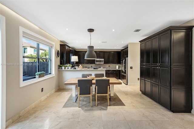 9835 NW 86th Ter, Doral, FL 33178 - kitchen with baseboards, stainless steel appliances, decorative backsplash, light countertops, and marble finish floor