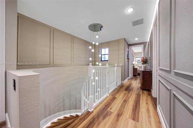 9835 NW 86th Ter, Doral, FL 33178 - corridor featuring light wood-type flooring, visible vents, an upstairs landing, and recessed lighting