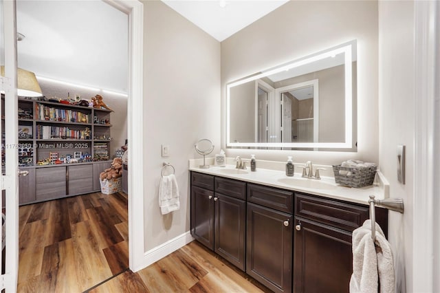 9835 NW 86th Ter, Doral, FL 33178 - bathroom with double vanity, wood finished floors, baseboards, and a sink