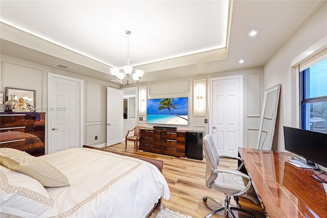 9835 NW 86th Ter, Doral, FL 33178 - bedroom with a tray ceiling, visible vents, an inviting chandelier, and light wood-style flooring
