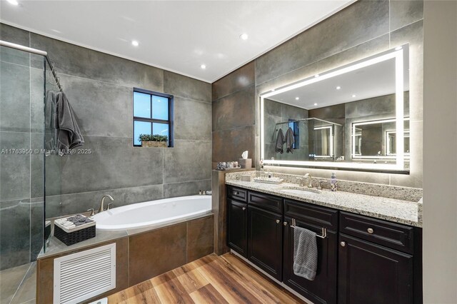 9835 NW 86th Ter, Doral, FL 33178 - full bath with visible vents, a shower stall, a garden tub, wood finished floors, and tile walls