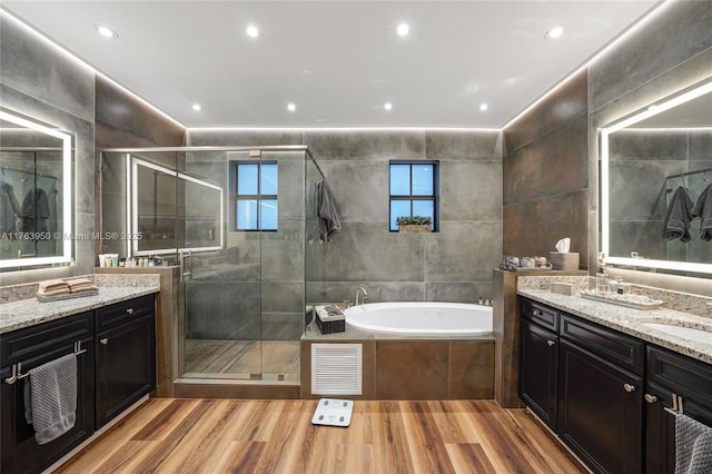 9835 NW 86th Ter, Doral, FL 33178 - full bathroom with wood finished floors, visible vents, a stall shower, tile walls, and a bath