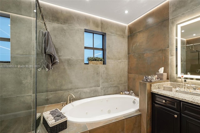 9835 NW 86th Ter, Doral, FL 33178 - bathroom with tile walls, a jetted tub, vanity, and a tile shower