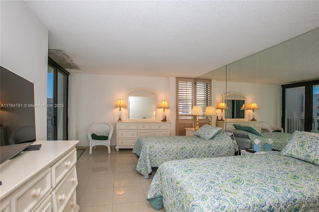 bedroom with light tile patterned floors and a textured ceiling