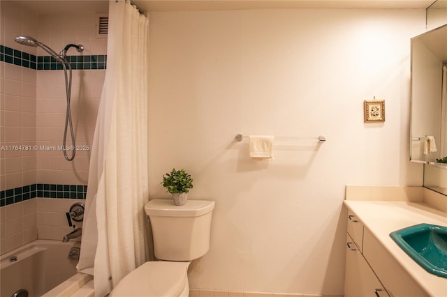 bathroom with vanity, toilet, and shower / bath combo