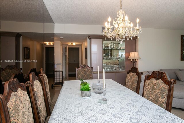 dining area featuring a textured ceiling and an inviting chandelier