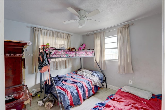 7501 NW 6th Ct, Miami, FL 33150 - bedroom with baseboards, cooling unit, wood finished floors, and a textured ceiling