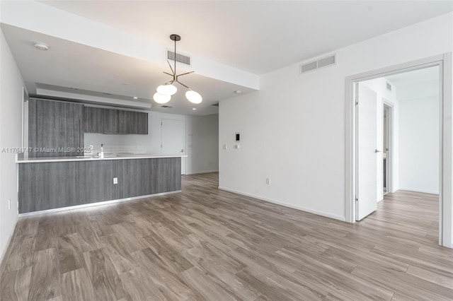 801 S Miami Ave Unit 3110, Miami, FL 33130 - unfurnished living room featuring a chandelier and light wood finished floors